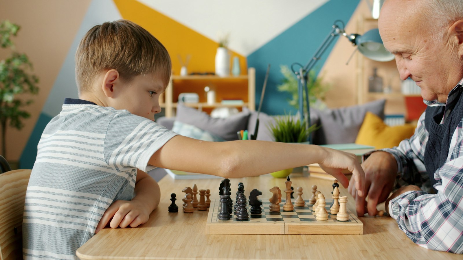 A mentor and child playing chess